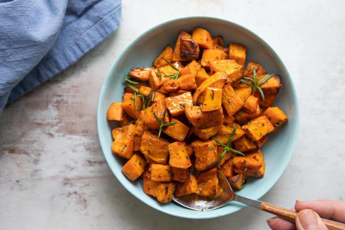 A bowl of cubed roasted sweet potatoes.