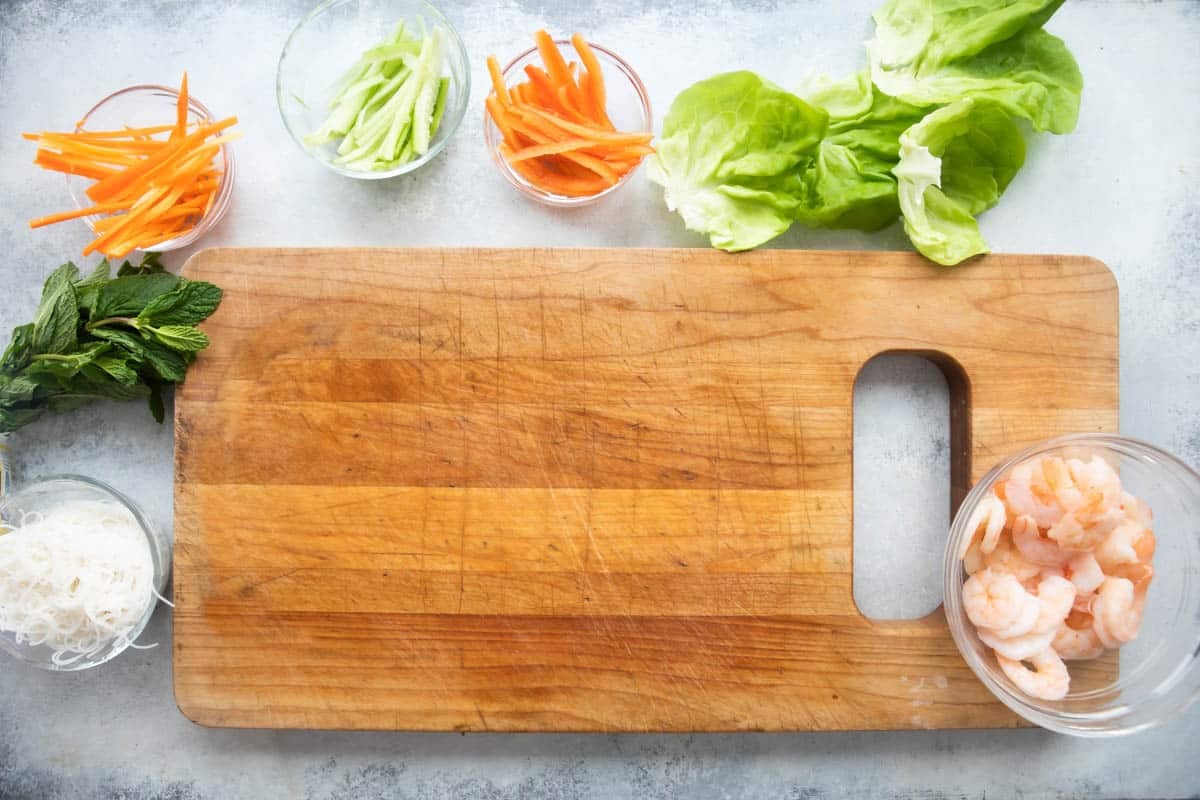 A cutting board for assembling Vietnamese spring rolls.