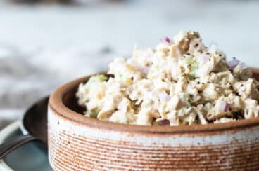 A brown bowl with tuna salad in it.